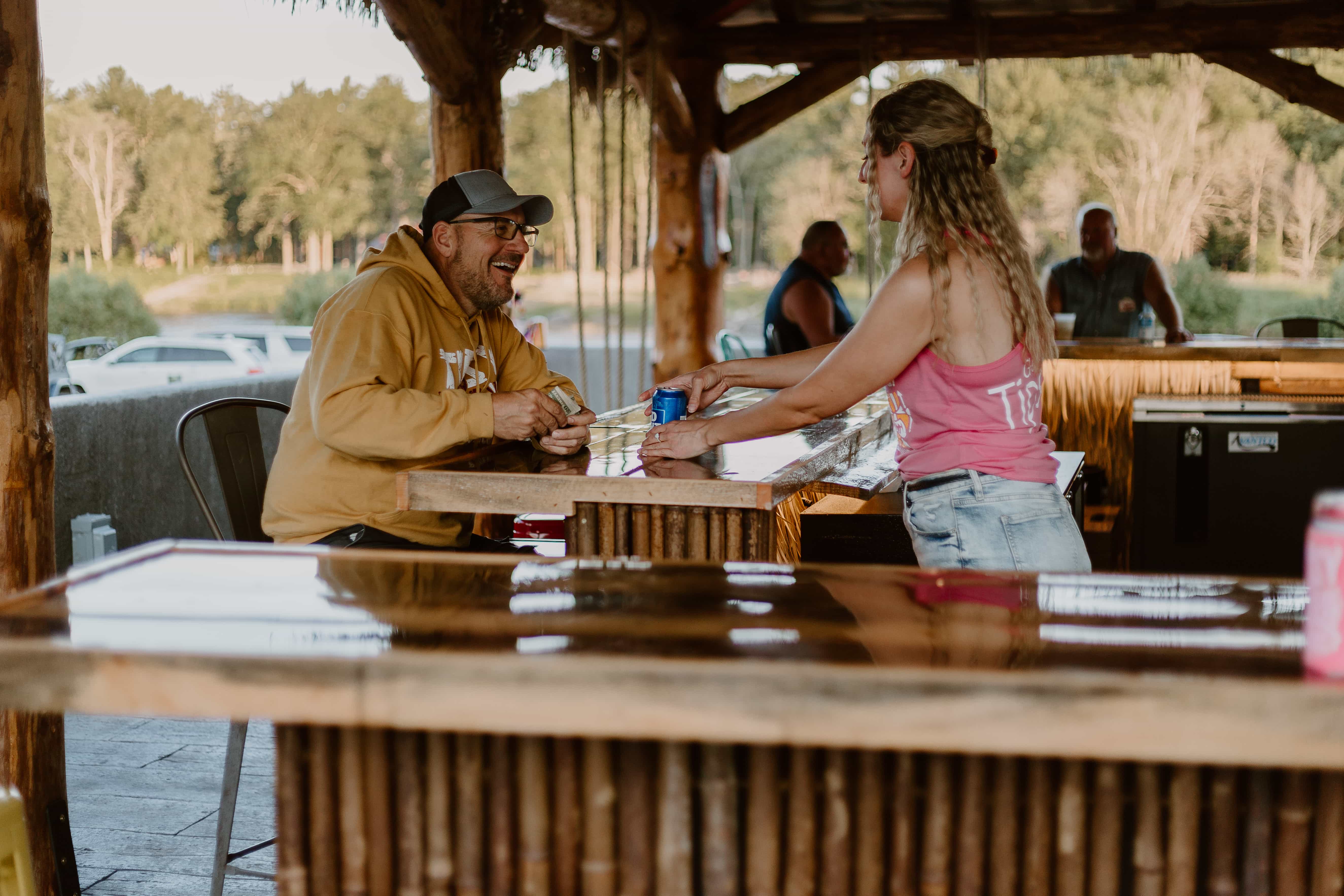 Friendly bartender serving drinks at Tipsy Tiki